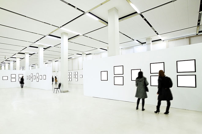 art enthusiasts viewing paintings in an art gallery