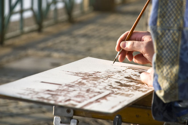 watercolor artist painting while traveling