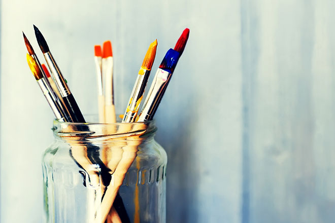 watercolor paintbrushes in a glass bottle