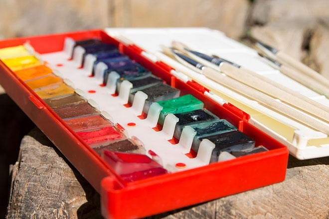 plastic watercolor palette with brushes